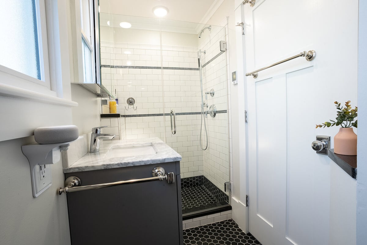 Small bathroom remodel featuring modern fixtures and a glass shower, designed by Oxland Builders in New Hampshire