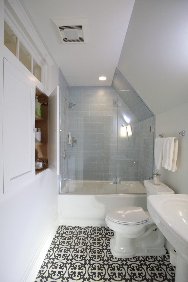 Stylish bathroom featuring patterned flooring and a clawfoot tub, designed by Oxland Builders in New Hampshire
