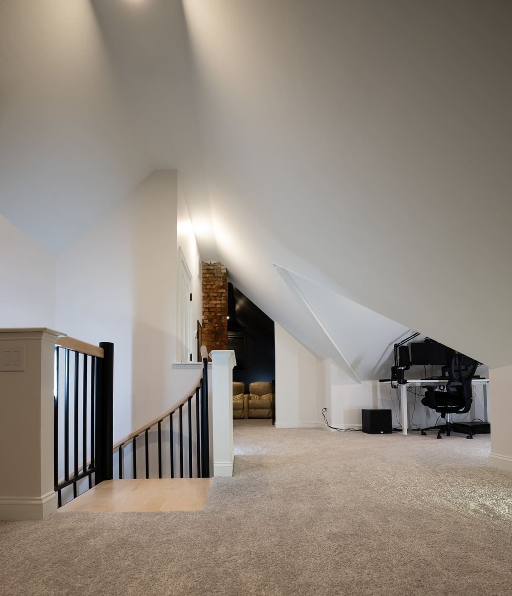 Top of curved staircase to finished attic with office space in Portsmouth remodel by Oxland Builders